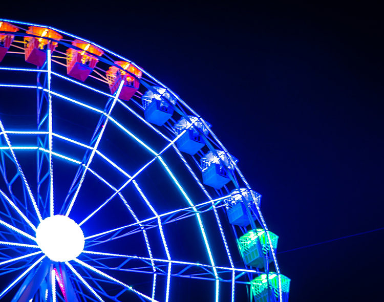 a colorful ferris wheel in the night