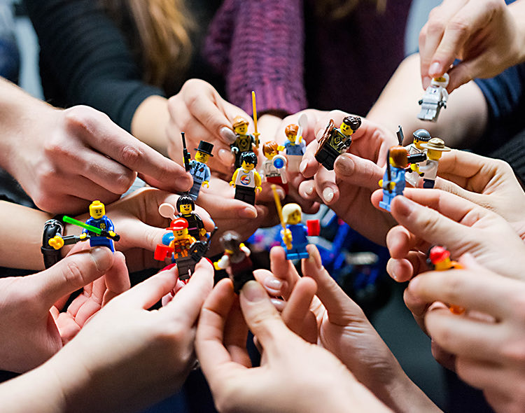 lots of hands holding legos