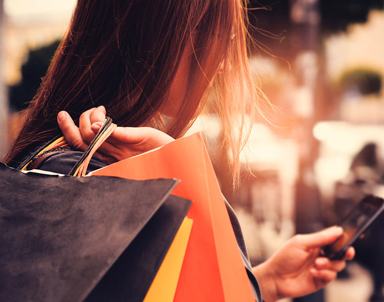 a woman carrying multiple shopping bags