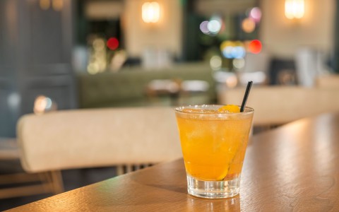 orange cocktail on bar