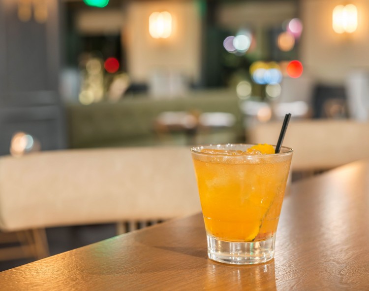 orange cocktail on bar