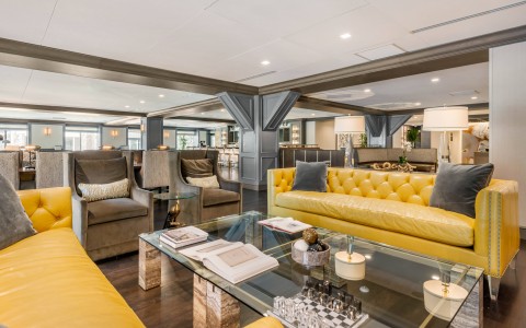 lobby with yellow sofas and table with chess and books
