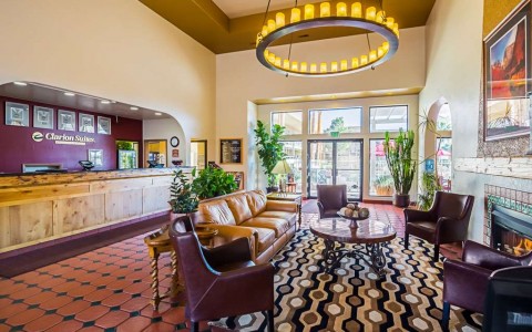 hotel lobby with seating area and a round chandelier 