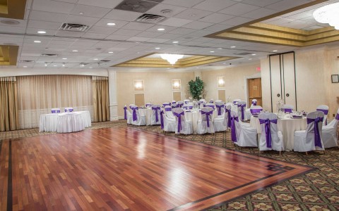 Ballroom with dance floor and banquet tables