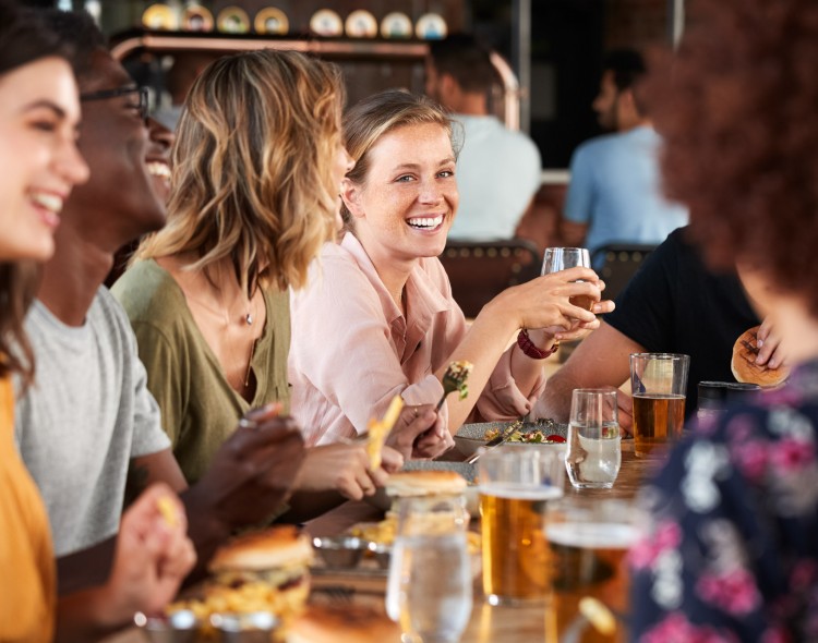 group of people at a table sharing drinks and laughs