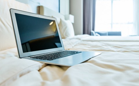 laptop sitting on top of bed