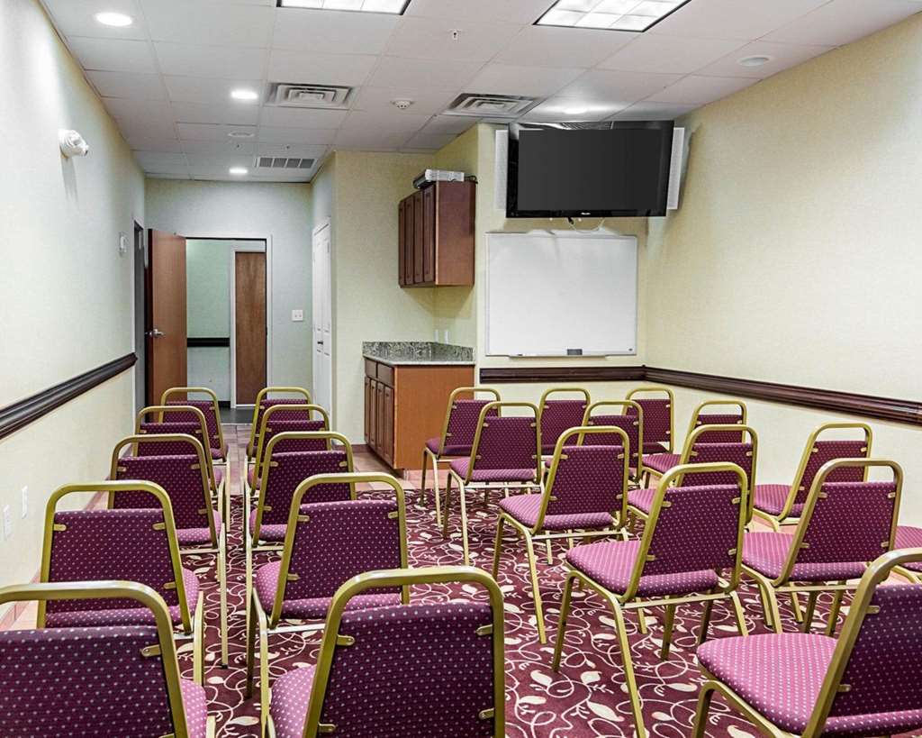meeting room set up with rows of chairs and a tv on the wall