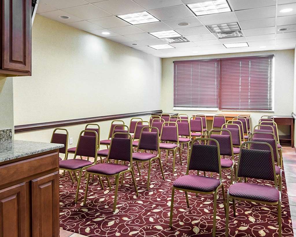 meeting room set up with rows of chairs facing a podium