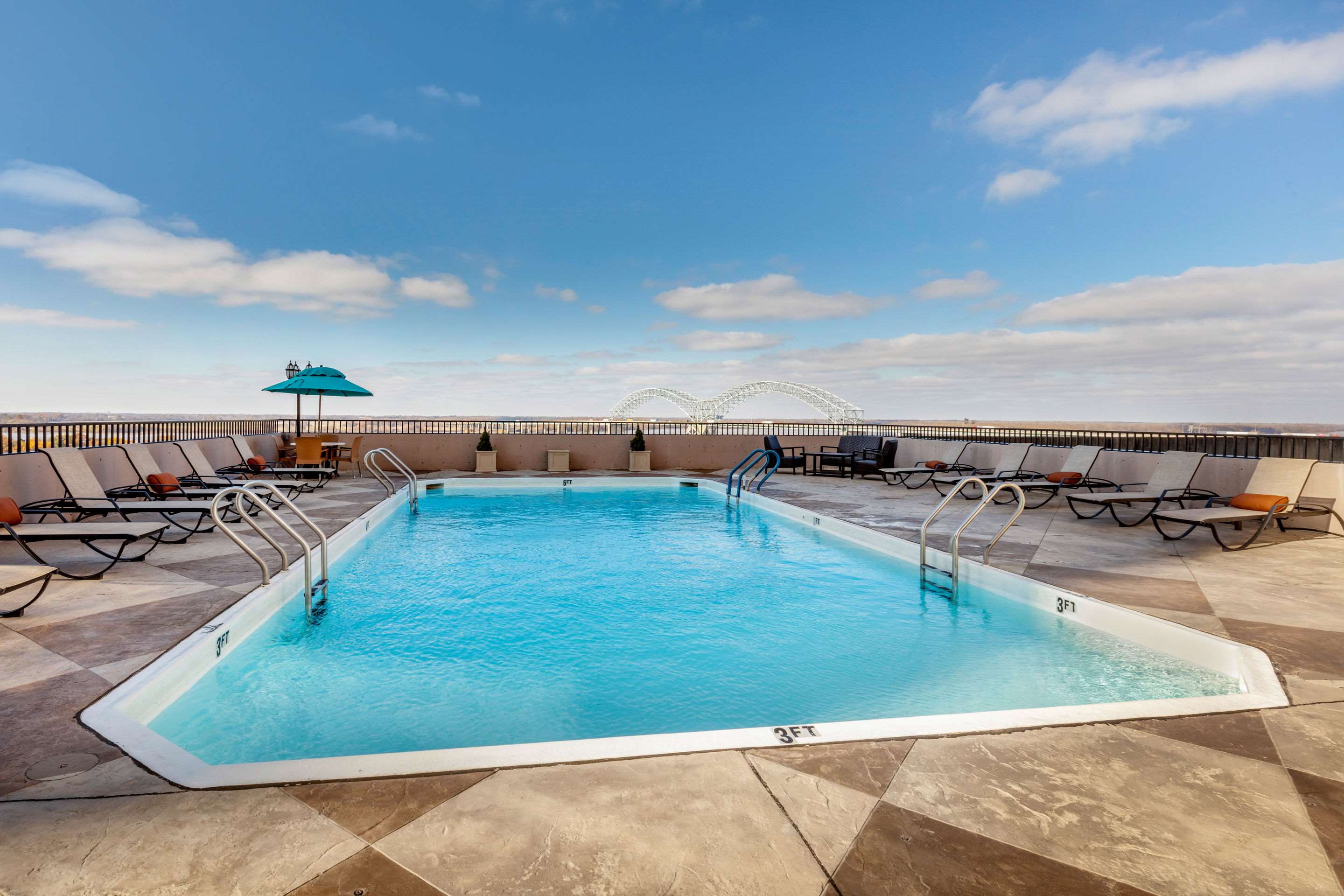 outdoor rooftop pool with lounge chairs around it