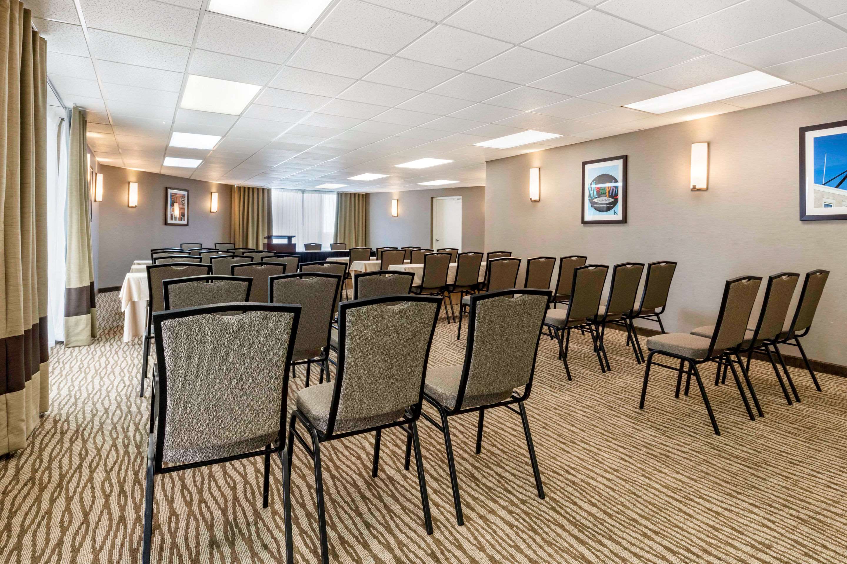 rows of chair in meeting room facing a podium