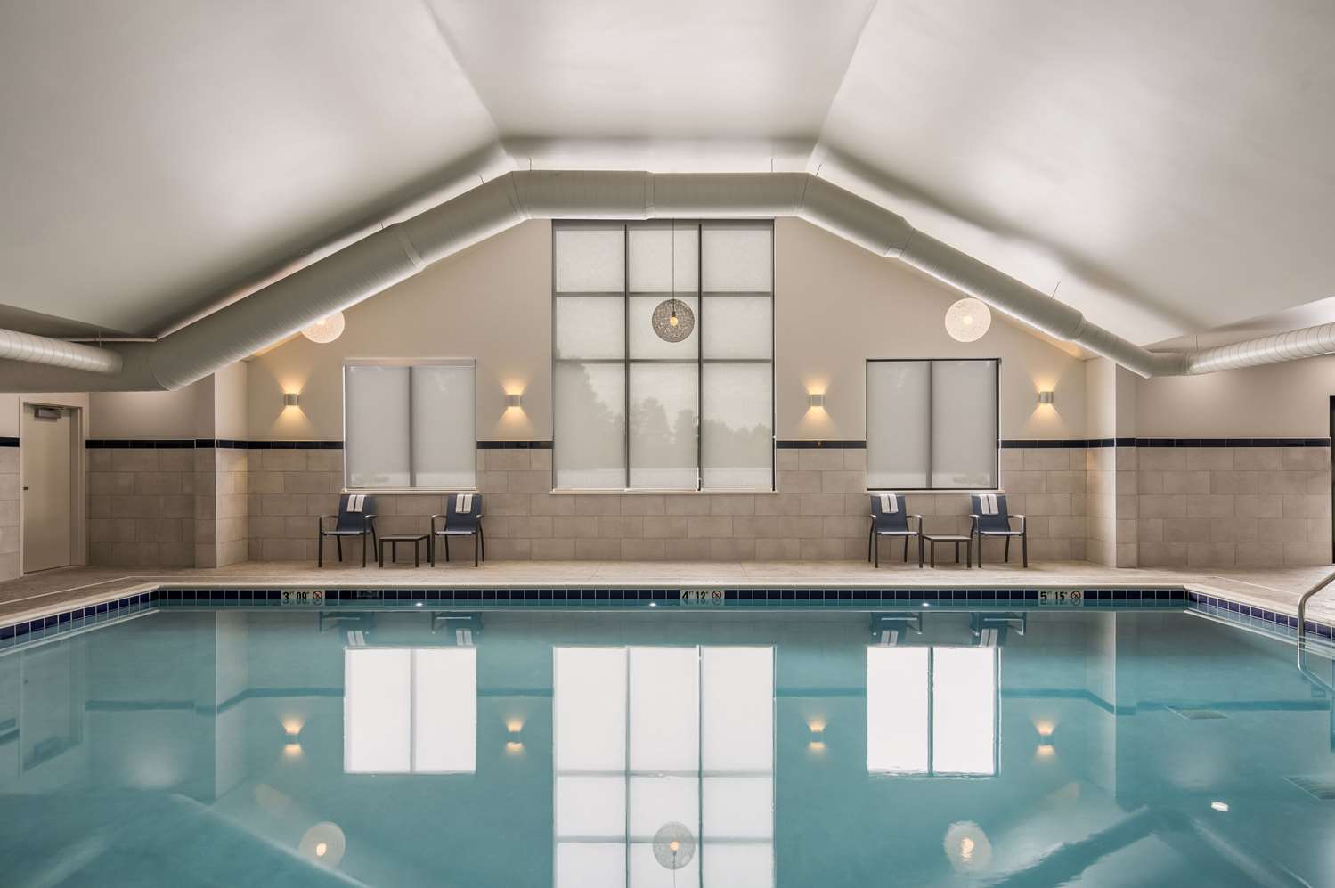 Indoor heated pool with 2 sets of chairs