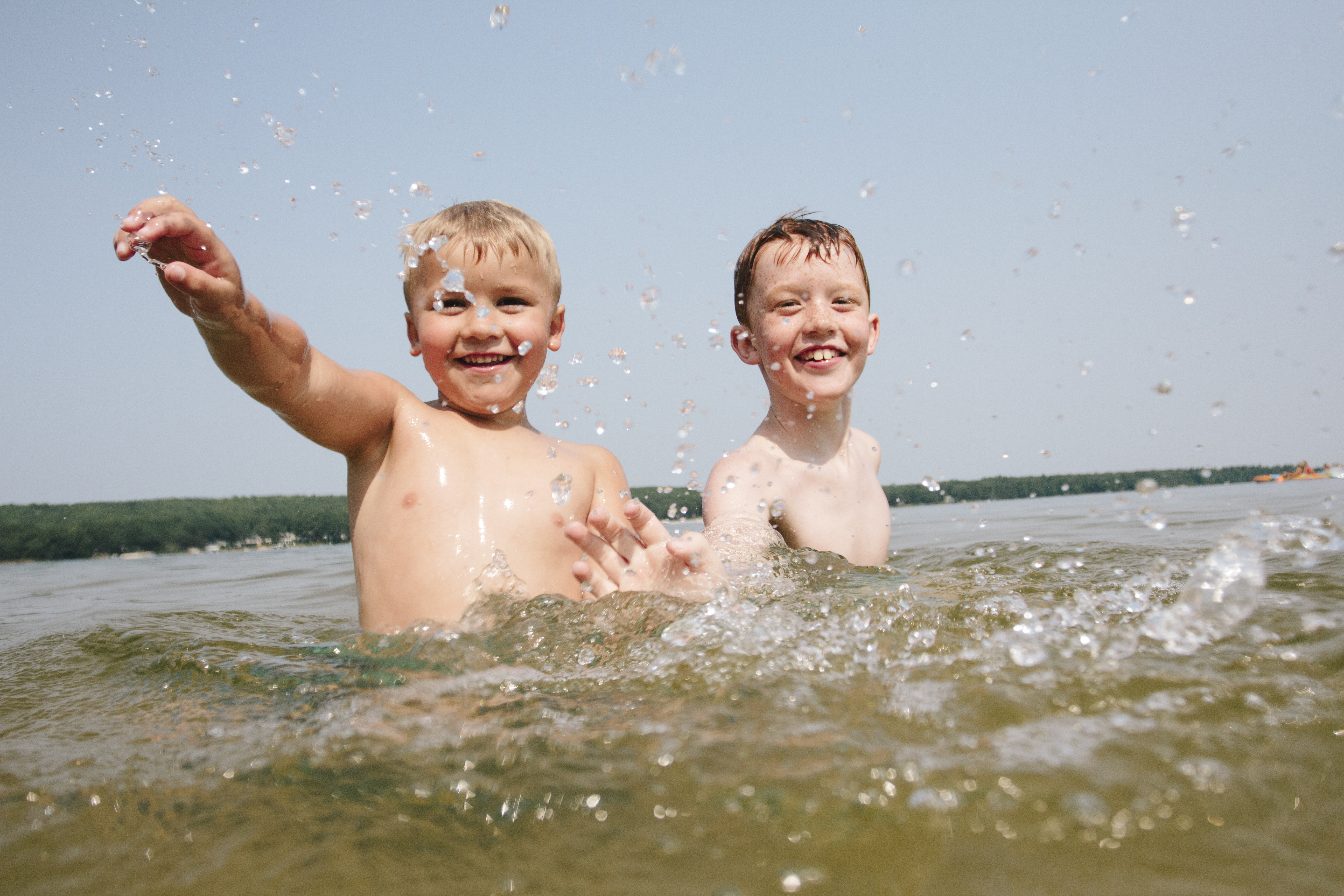 2 boys playing in lake