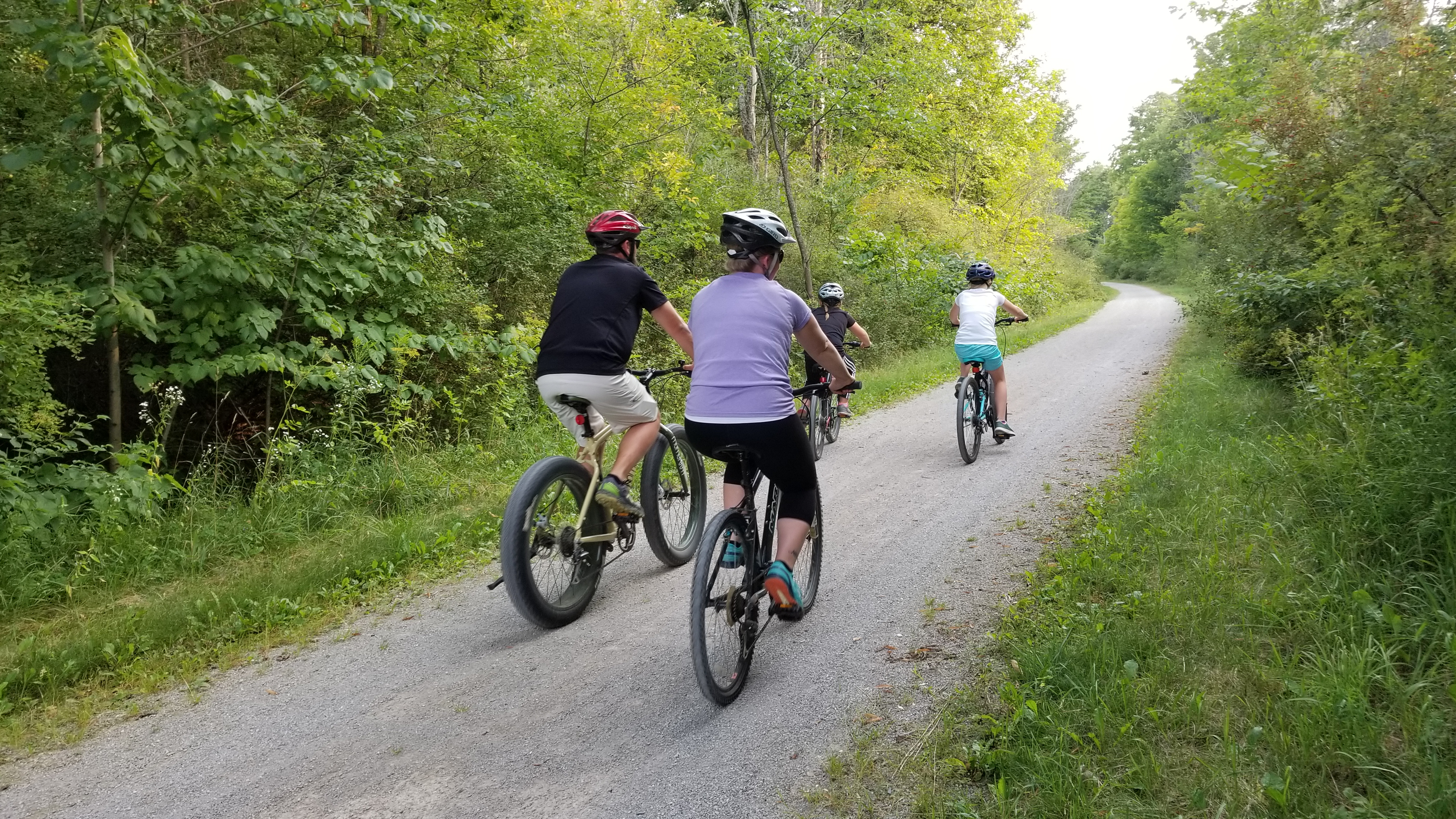 family biking down trail