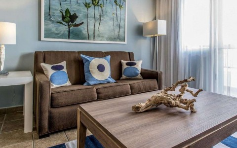 Spacious suite with brown sofa sleeper and coffee table