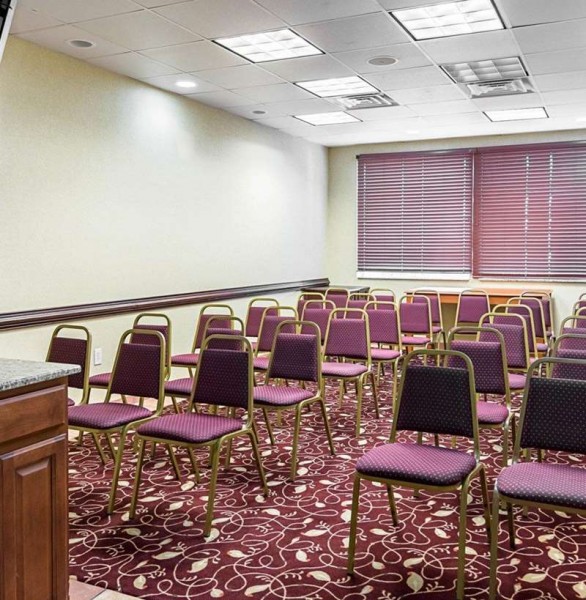 meeting room set up with rows of chairs facing a podium