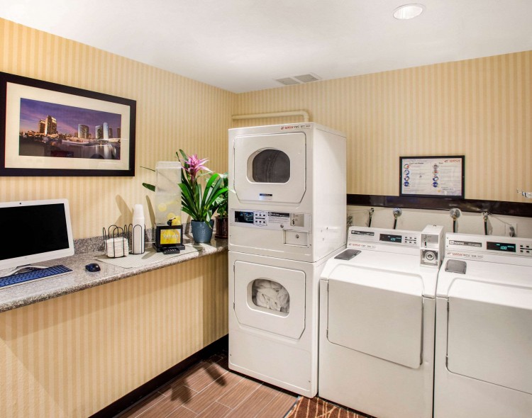 two washers and dryers in guest laundry facility along with computer