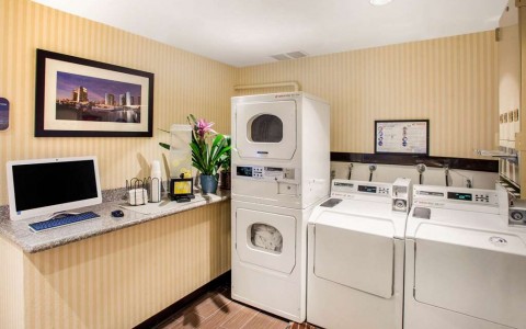 two washers and dryers in guest laundry facility along with computer