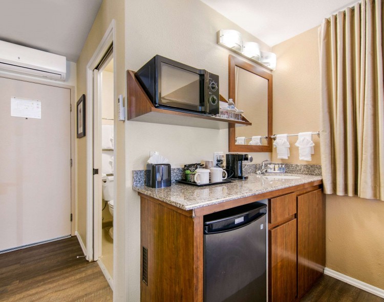 kitchenette area in guest room with mini fridge, coffee maker, microwave, and sink