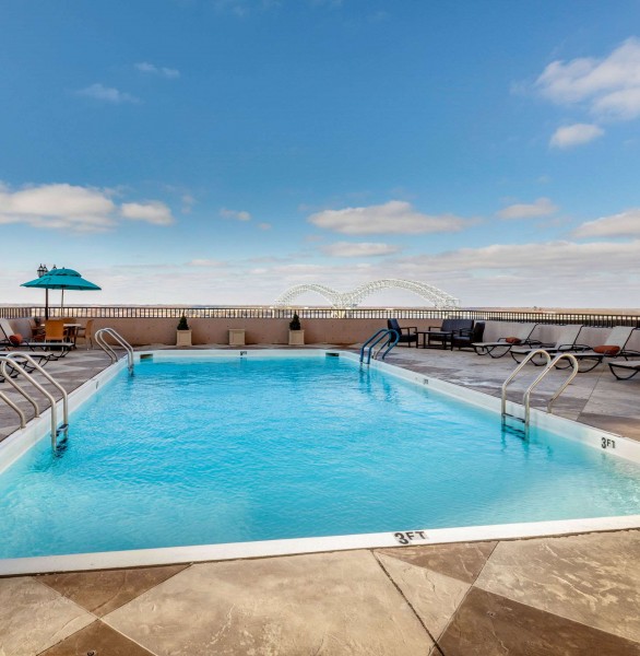 outdoor rooftop pool with lounge chairs around it
