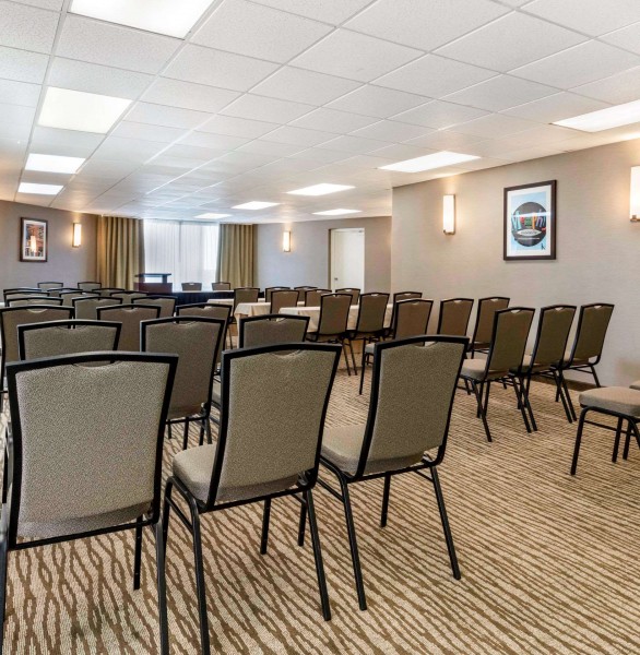 rows of chair in meeting room facing a podium