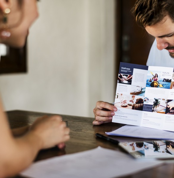 man presenting pamphlet to woman