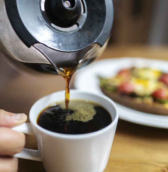 coffee being poured into a mug from a pot
