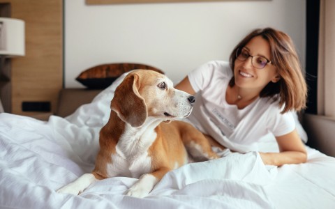 woman in bed with dog