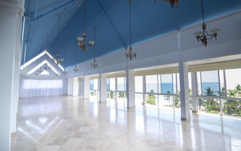 event space with vaulted ceiling and large windows
