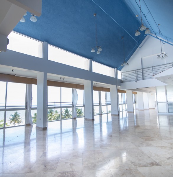 event space with vaulted ceiling and large windows
