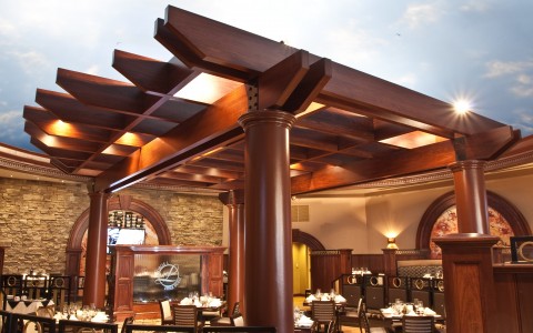restaurant ceiling that looks like blue sky and wooden trellis