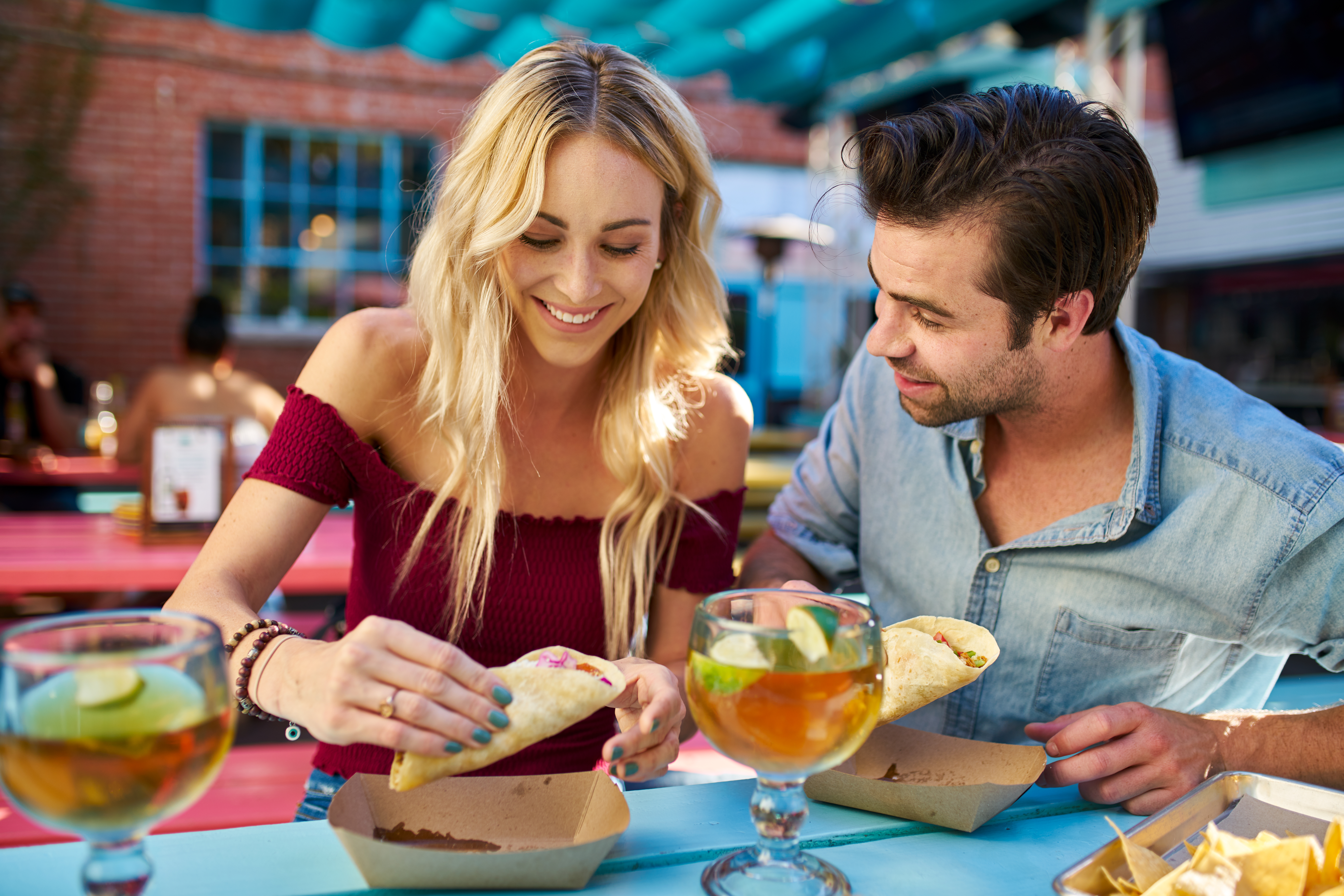 woman and man eating tacos