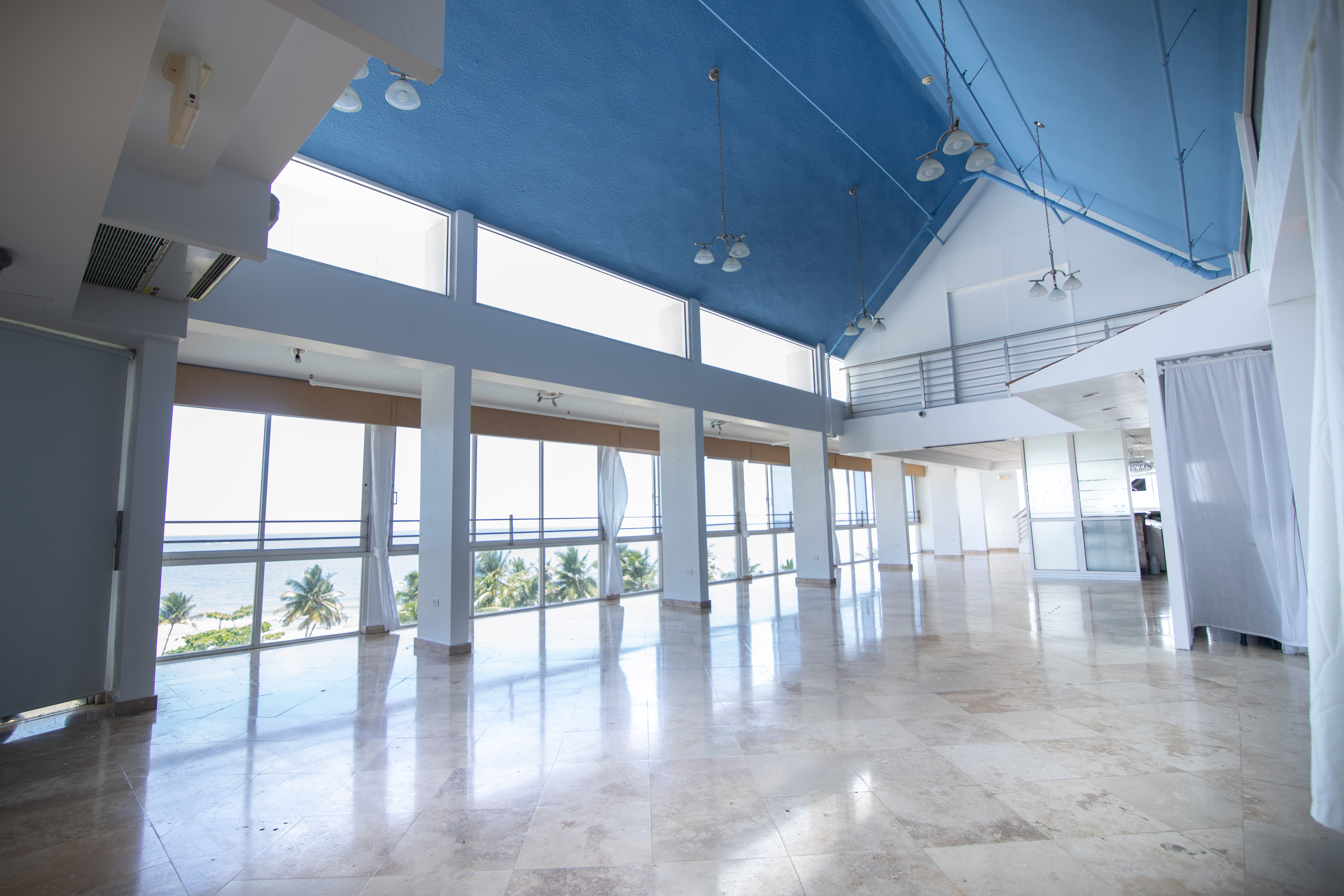 event space with vaulted ceiling and large windows