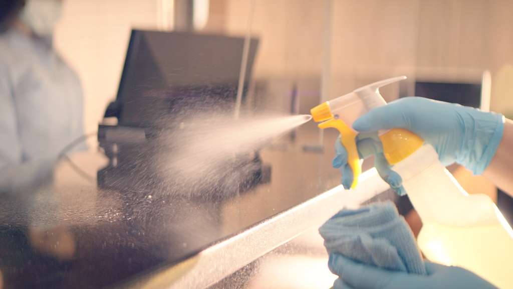 disinfectant being sprayed on countertop