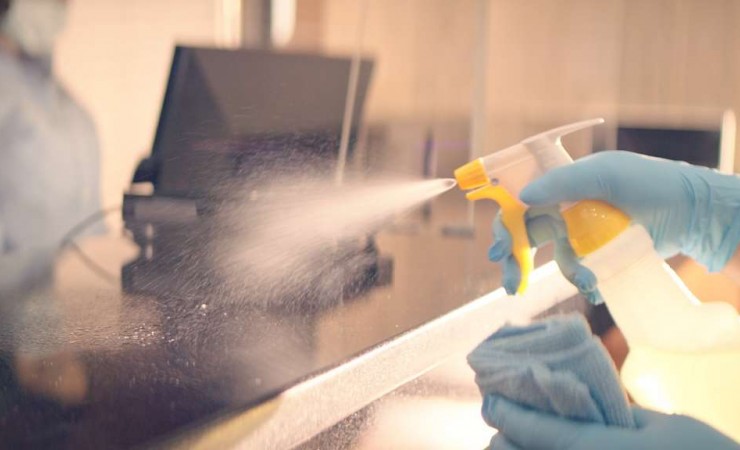 disinfectant being sprayed on countertop