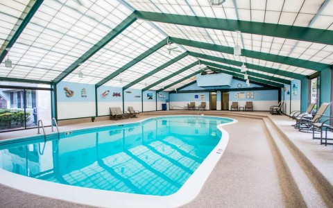 indoor pool with chairs around it