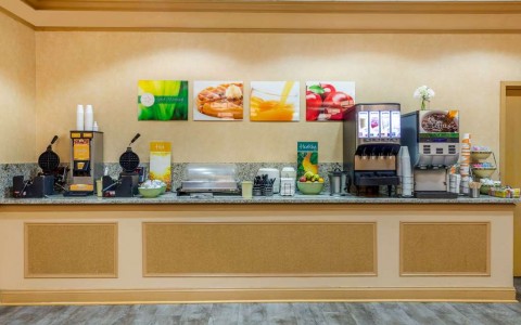breakfast counter with juice dispensers and waffle makers