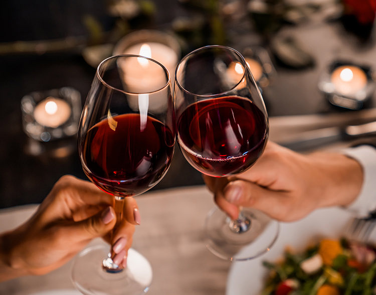 couple clinking their glasses of red wine