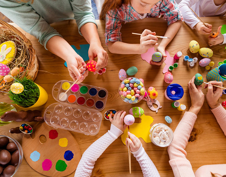 group of people painting easter eggs
