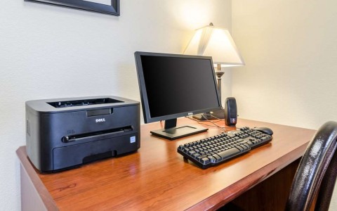computer and printer at a desk in the business center