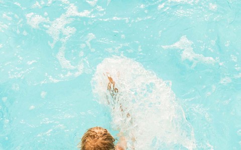 young child swimming in the pool