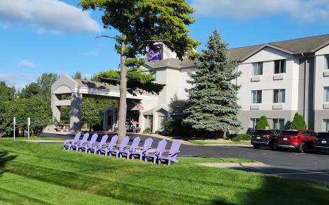 exterior of hotel with purple chairs in front