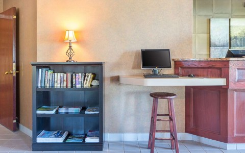 Business center with computer and bookshelf