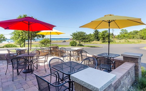 outdoor picnic area with yellow and red umbrellas