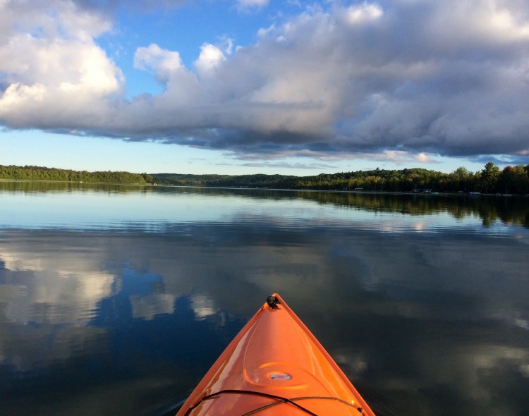 kayak on beautiful lake surrounded by greenery