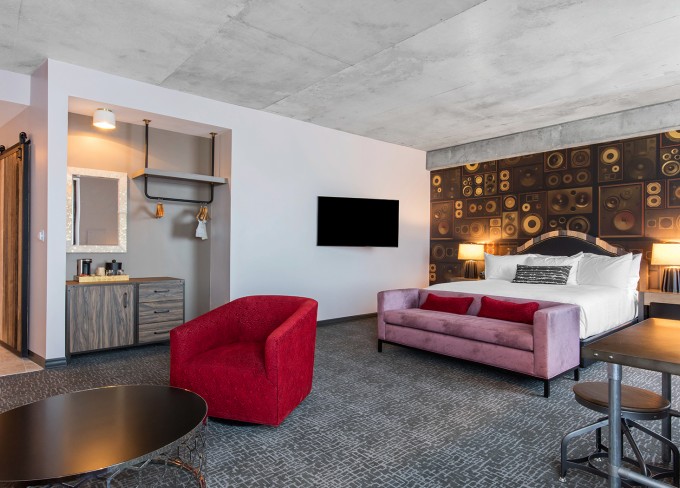 Corner view of King suite accommodation with features as comfy sofas, circle table and lamps 