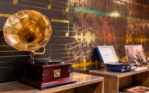 closeup view of phonograph, disco playera and old disc in the desk