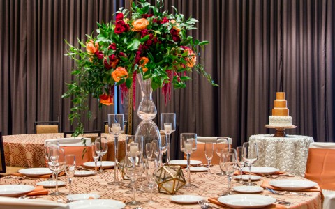View of a big circle setup table for a event with a bouquet of roses decoration in the table