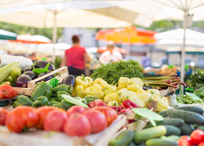 Street market with some eggplants, tomato and cucumber at daytime