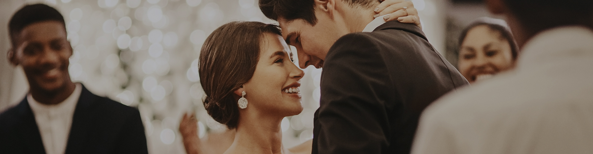 closeup image of a bride and a groom smiling looking at each other 