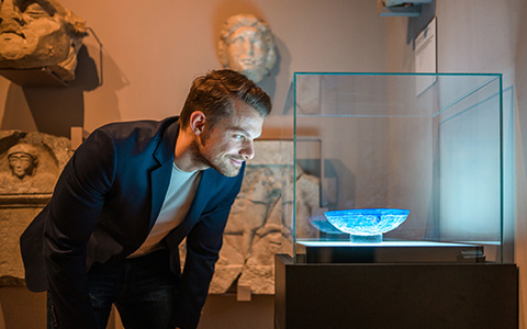 a man watching an artifact at the museum 